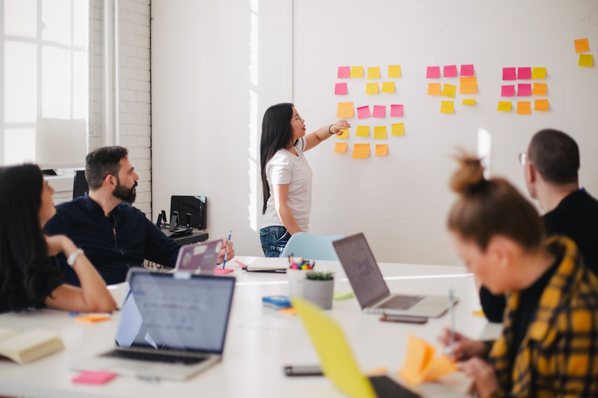Economic analysts reviewing data and reports in a bright meeting room
